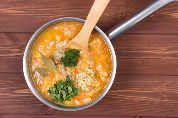 Wooden spoon and ingredients on dark background. Vegetarian food, health or cooking concept