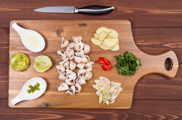 Wooden spoon and ingredients on dark background. Vegetarian food, health or cooking concept