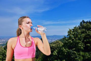 Portrait Of Young Woman Drinking Water After Jogging