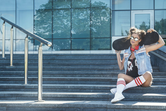 Stylish girl with a skateboard