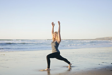 Fototapeta na wymiar Woman does yoga on the beach