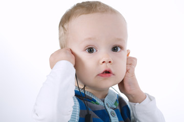 cute boy listens music with headphones