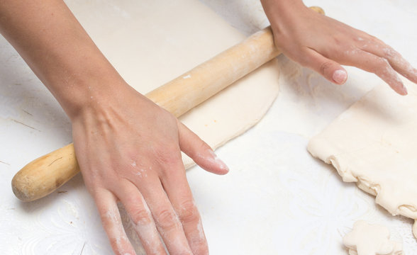 rolling the dough in the kitchen