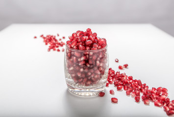 Fresh red pomegranate seeds sprinkled in a glass