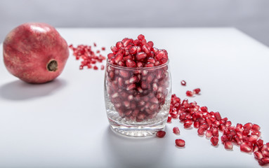 Fresh red pomegranate seeds sprinkled in a glass