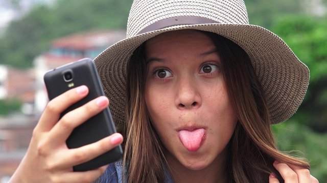 Adorable Teen Girl Making Selfies And Funny Faces