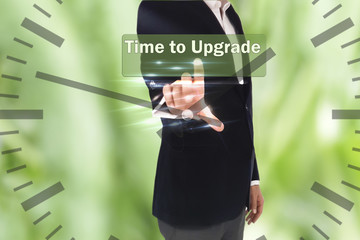 Businessman pressing time to upgrade word on virtual button 