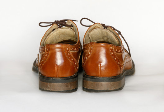 Pair Of Used Men's Brown Dress Shoes Isolated On White.