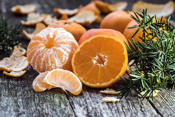 Ripe Mandarin fruit peeled open and place on old rustic look tim