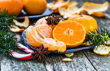 Ripe Mandarin fruit peeled open and place on old rustic look tim