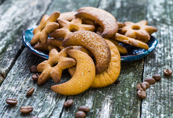 Plate with tasty Christmas cookies on wooden table