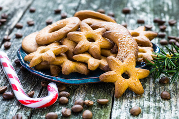 Plate with tasty Christmas cookies on wooden table