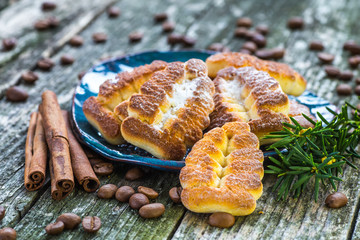 Plate with tasty Christmas cookies on wooden table