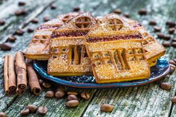 Plate with tasty Christmas cookies on wooden table