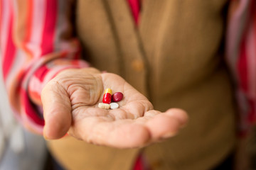 senior woman holding pills