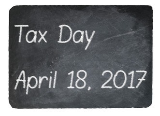 Obraz premium Tax Day concept using chalk on slate blackboard