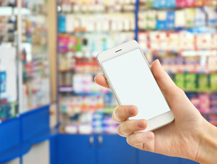 Man with smartphone in store, closeup. Blank screen.