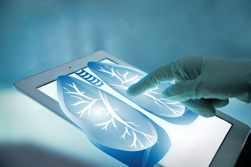 Doctor with tablet, closeup. Lungs on screen. Medicine and modern technology concept.