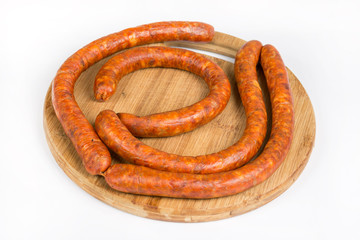 Raw homemade domestic sausage on the wooden board. Flat lay with