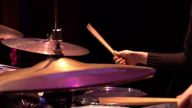 Drummer playing on the concert. Slow motion view.