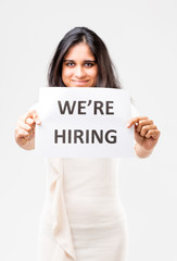 indian girl holding a hiring sign