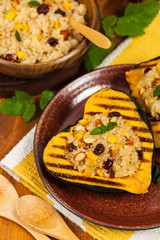 Roasted Pumpkin Stuffed with Quinoa, Nuts and Dried Fruit. Selective focus.