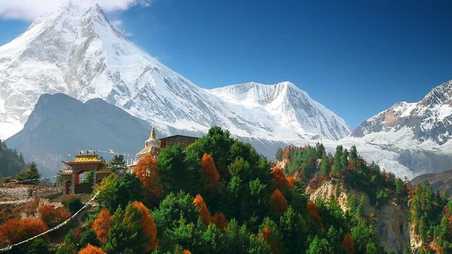 Traditional Buddhist monastery and Manaslu mount in Himalayas, Nepal. Autumn, view from Manaslu circuit trek
