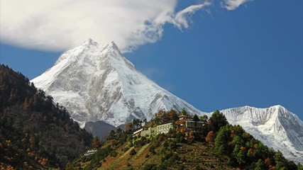 Traditional Buddhist monastery and Manaslu mount in Himalayas, Nepal. Autumn, view from Manaslu circuit trek
