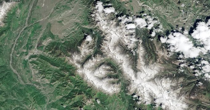 High-altitude overflight aerial of the Grand Tetons and surrounding land, Wyoming. Clip loops and is reversible. Elements of this image furnished by USGS/NASA Landsat 

