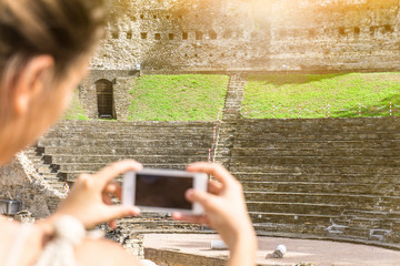 Tourist woman taking photos with her smartphone of old architecture - Concept about travel and technology - De focused girl

