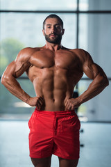 Obraz na płótnie Canvas Healthy Young Man Flexing Muscles