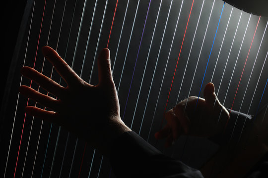 Harp strings Hands playing musical instruments