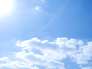 A bright sunny morning sky with clouds.