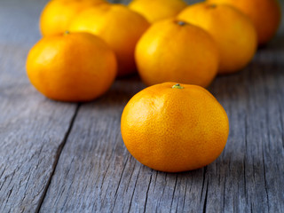 tangerines on wooden board, shallow depth of field