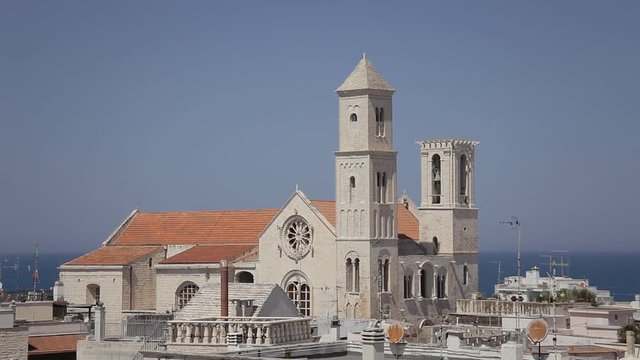 GIOVINAZZO, Italy - AUGUST 9, 2016: the church of Santa Maria Assunta, view from a high place. Italian romanic style. Archival, context, establishing.
