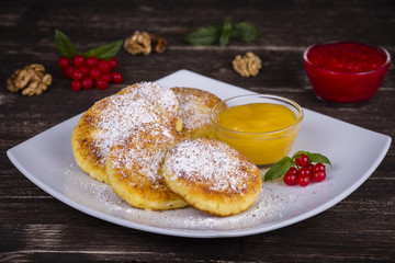 Cheese pancakes with honey in white plate.