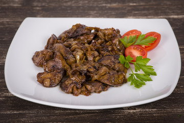 Chicken livers in a creamy sauce with onion on white plate