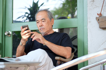 senior man enjoying on his phone