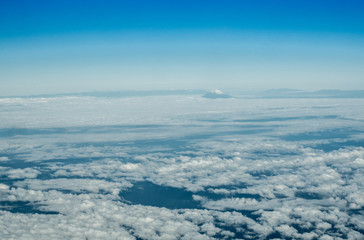 Fototapeta na wymiar Blue perfect sky sea of clouds from high altitude space background