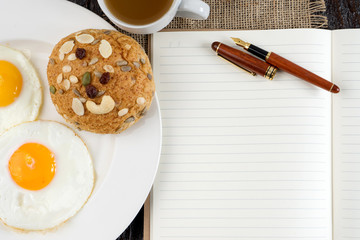 breakfast with white book paper and pen top view