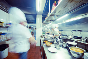motion chefs of a restaurant kitchen