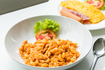 Macaroni and tomato sauce with chicken meat decorated with scall