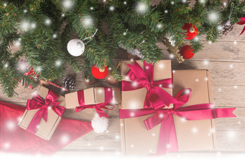 Fototapeta na wymiar Brown gift box and christmas tree on wooden background