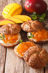Sweet sandwiches with mango jam, butter and mint close-up. vertical