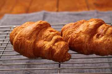 Baked croissants on a cooling rack