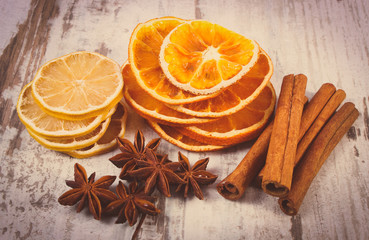 Vintage photo, Slices of dried lemon, orange and spices on old wooden background