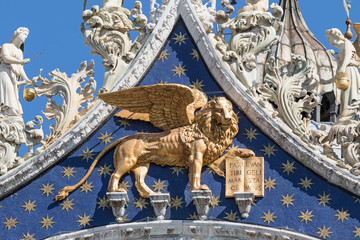 Closeup view of winged golden lion statue on the roof of the Cathedral of San Marco (Venice,...