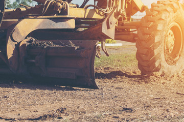 Obraz premium Grader leveling landfill on construction site before kick off project