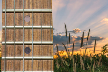 Close-up the Guitar neck aligned, Rosewood fingerboard neck on fantastic heaven sunset on...