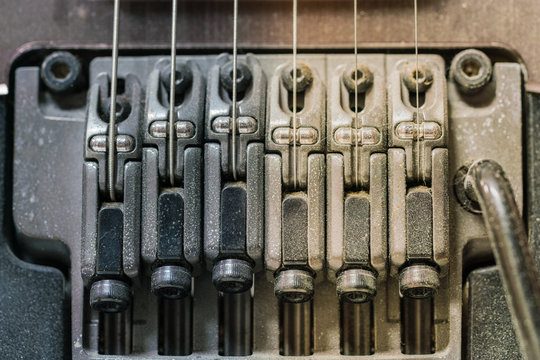 Detail of electric guitar pickups with dust, Close up shot of dirty Electric guitar tremolo - vintage effect style.
